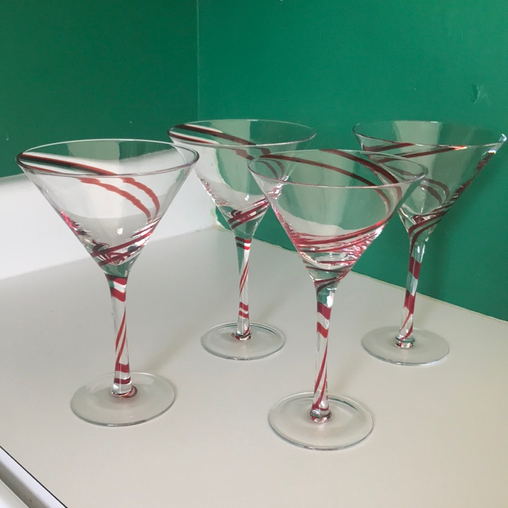 A set of four glass red swirled martini glasses, perfect for the holiday season!